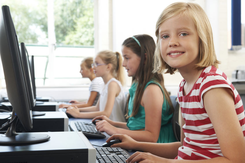 43055760-Group-Of-Female-Elementary-School-Children-In-Computer-Class-Stock-Photo